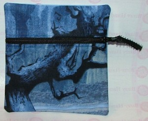 After the second tote was done there wasn't much left but scraps. I wanted to make sure that I used as much of the panel as possible, not only for my client but also because I hate to waste fabric.  I found enough to make this zippered change pouch.  